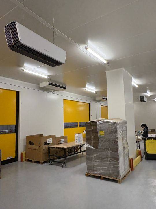 Purificateurs d'air suspendus au plafond d'une zone de préparation de commandes
